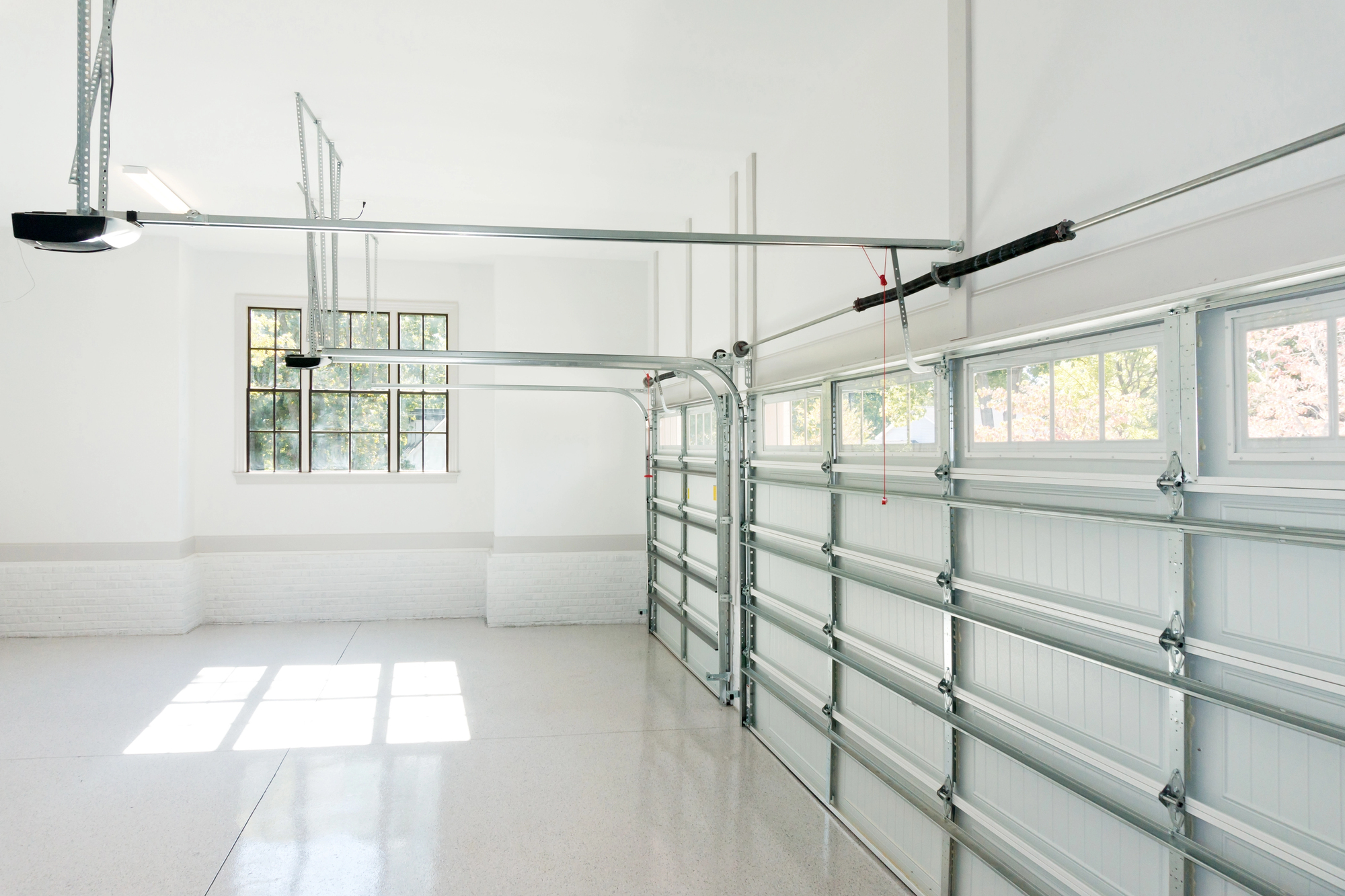 garage with a closed door and window - Innovative Garage Flooring residential flooring