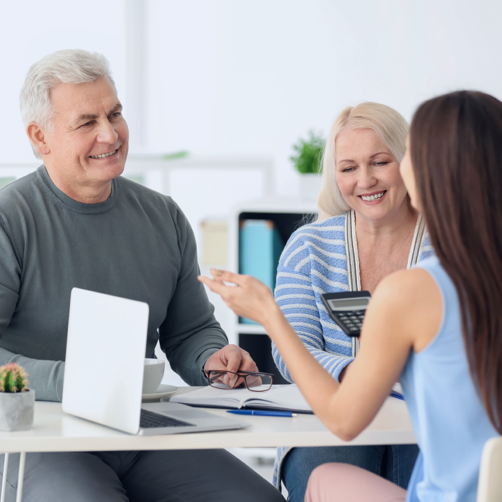 man with black glasses smiling at laptop - Innovative Garage Flooring