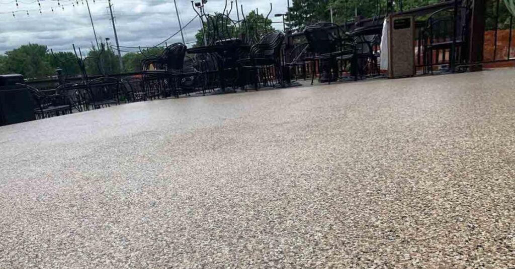 commercial patio space with furniture stacked up - Innovative Garage Flooring epoxy flooring