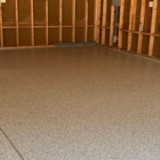 epoxy floor in a garage with wood stud walls - Innovative Garage Flooring epoxy flooring contractors near