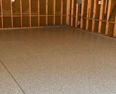 epoxy floor in a garage with wood stud walls - Innovative Garage Flooring epoxy flooring contractors near