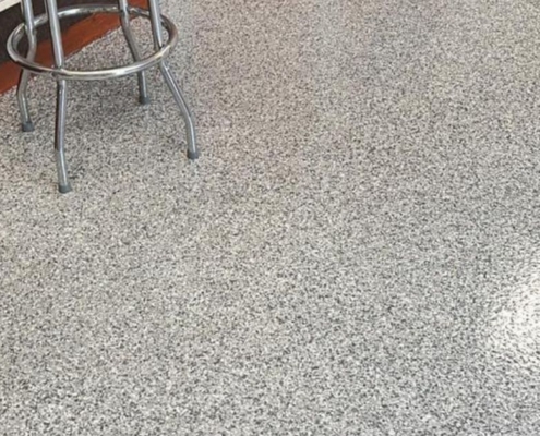 epoxy floor with a metal stool - Innovative Garage Flooring epoxy flooring contractors near