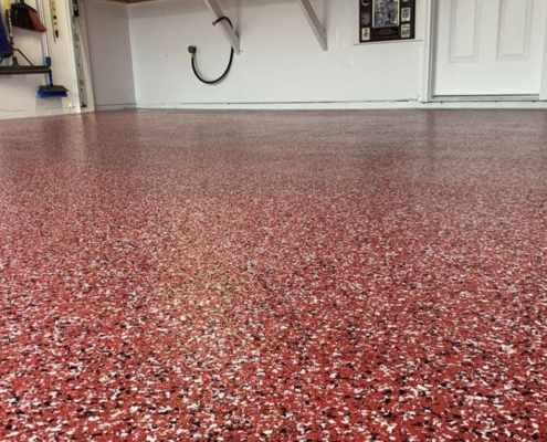 epoxy flooring with a red base and black and white flakes - Innovative Garage Flooring epoxy flooring contractor near