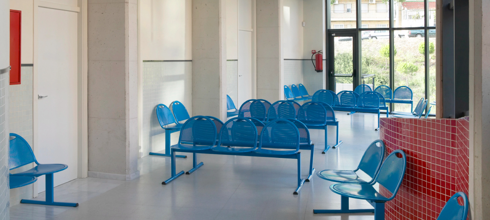 rows of empty blue and metal chairs - Innovative Garage Flooring epoxy flooring for healthcare & medical facilities