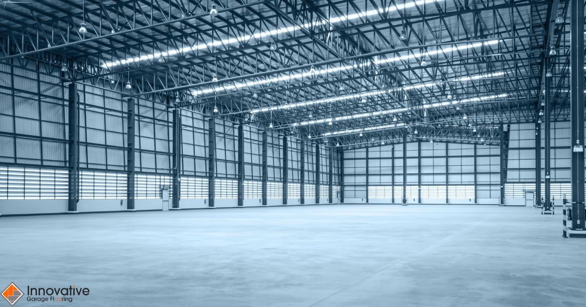 empty warehouse with exposed metal beams - Innovative Garage Flooring Epoxy Flooring for Industrial & Manufacturing Facilities