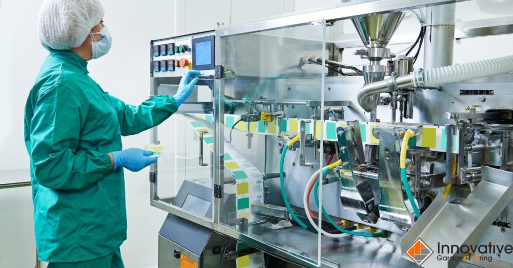 factory worker pressing buttons for pharmacy machine - Innovative Garage Flooring industrial epoxy flooring