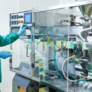 factory worker pressing buttons for pharmacy machine - Innovative Garage Flooring industrial epoxy flooring