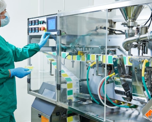 factory worker pressing buttons for pharmacy machine - Innovative Garage Flooring industrial epoxy flooring