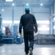 man in a factory wearing a hard hat and holding a clipboard - Innovative Garage Flooring industrial epoxy flooring