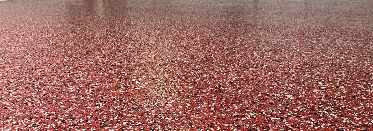 close up of full flake epoxy flooring with red flakes - Innovative Garage Flooring full flake epoxy flooring