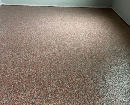 close up of full flake epoxy flooring with grey flakes - Innovative Garage Flooring full flake epoxy flooring