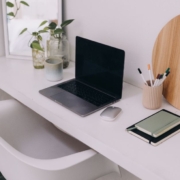 workspace with a white desk and silver laptop - Innovative Garage Flooring Commercial Flooring Solutions